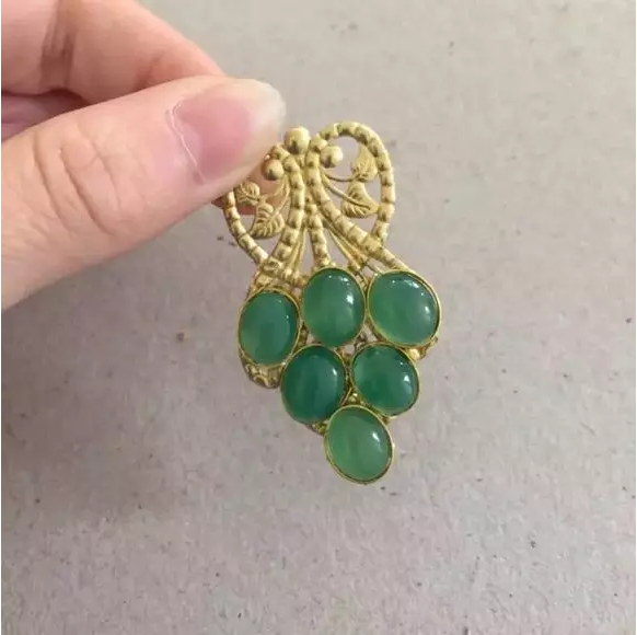 9、固定你的葡萄叶子w拿铜丝缠紧用胶固定。依次都固定好。这里用的是珠宝胶，如果要用铜丝固定一定要在戒面胶水干透了之后再下手哦，不然戒面会掉下来的嗷